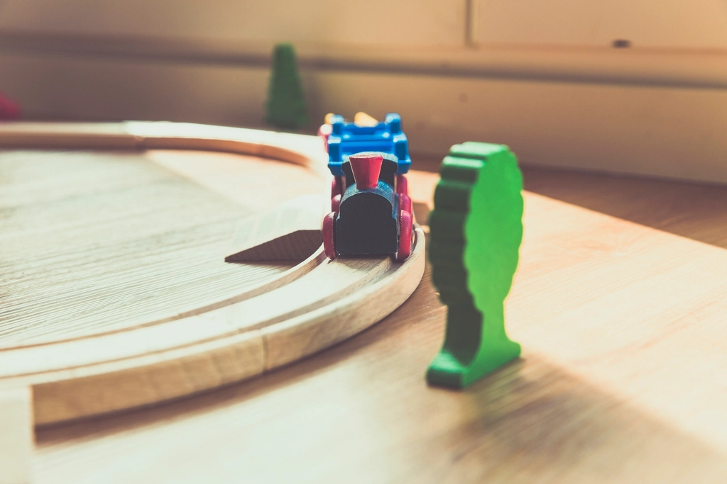 Handmade wooden toy train on a curved wooden track