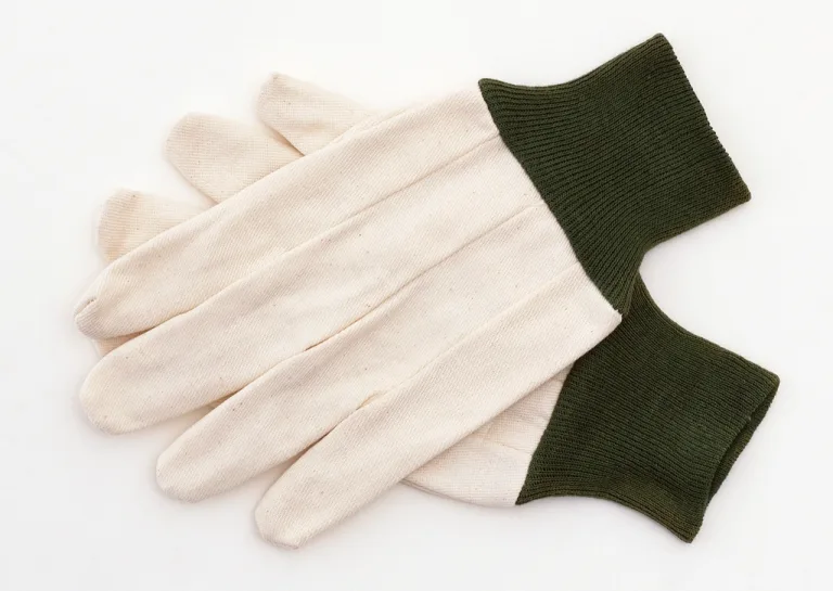 A pair of canvas work gloves with green cuffs on a white background