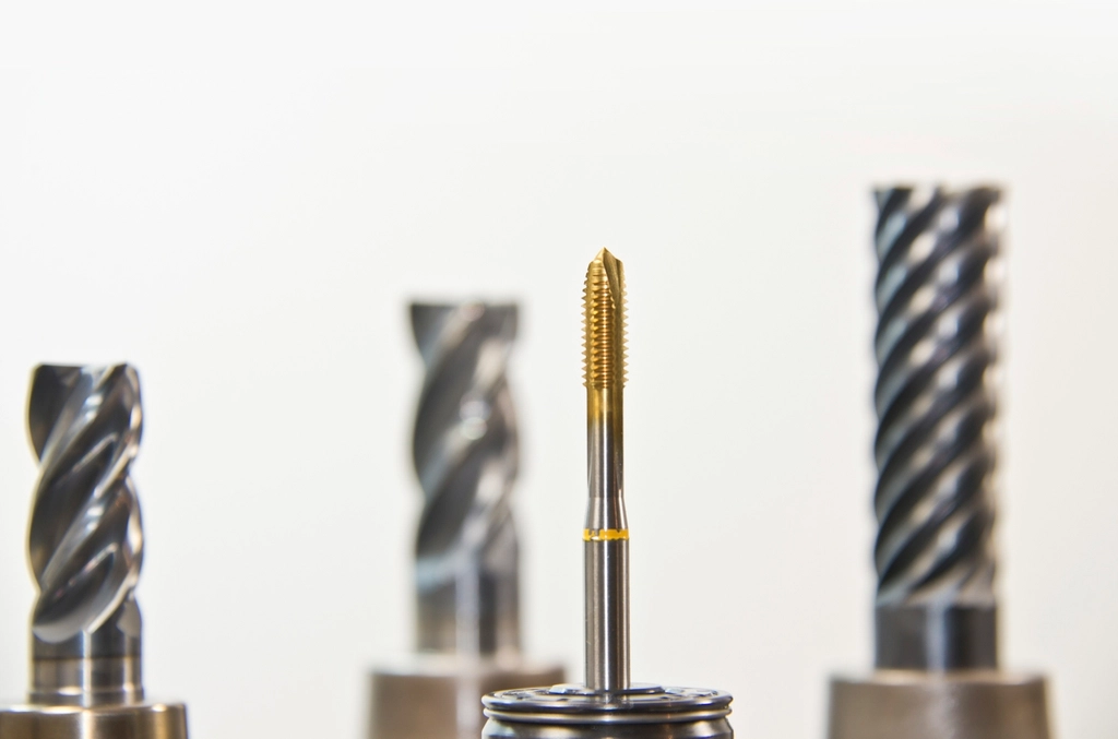 Close-up of spiral end mill router bits standing upright on a workbench