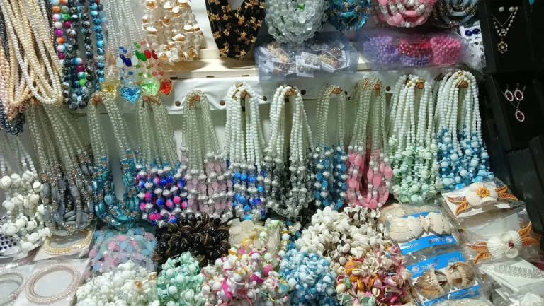 Handmade necklaces displayed at a craft market stall