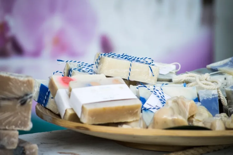 Bars of handmade soap wrapped with twine on a wooden platter