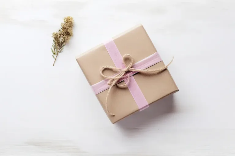Small gift box wrapped in kraft paper and tied with ribbon