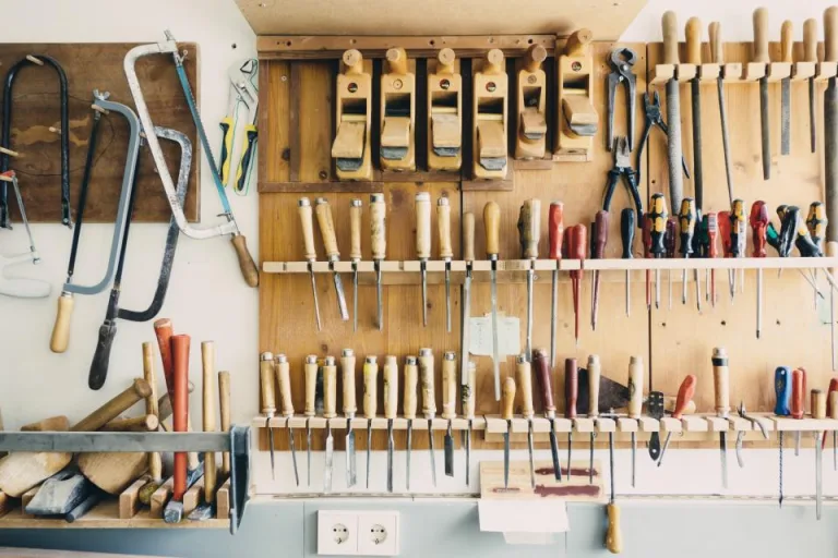 Organized wall of hand tools in a home workshop