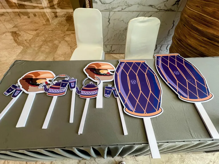 Photo booth props on sticks laid out on a table at an event