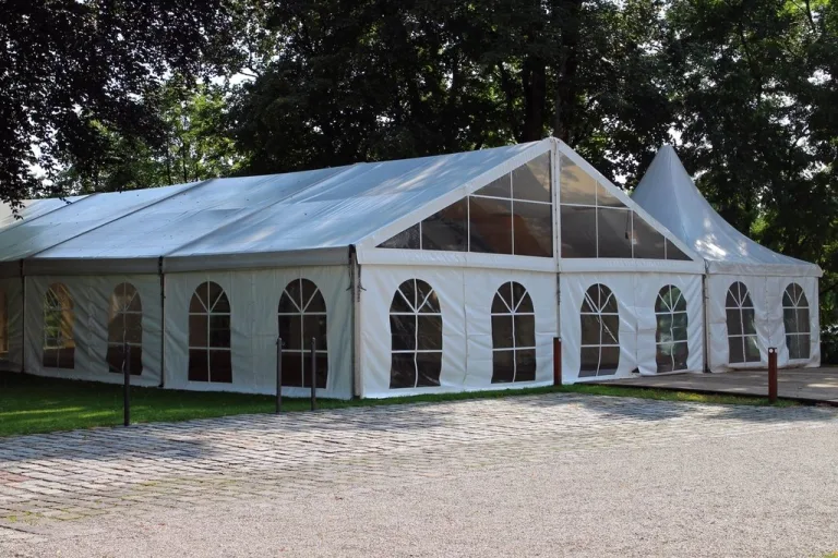 White event tent set up on a lawn