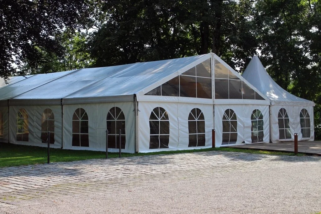 White event tent set up on a lawn